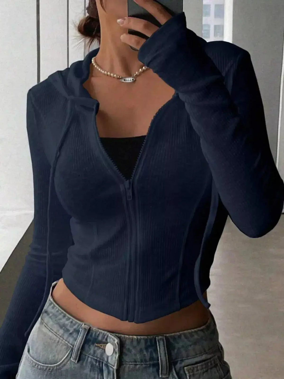 Women's ribbed knit cropped zip-up jacket in hoodie style from Plush Fashion Hub, featuring a fitted design and front zipper.