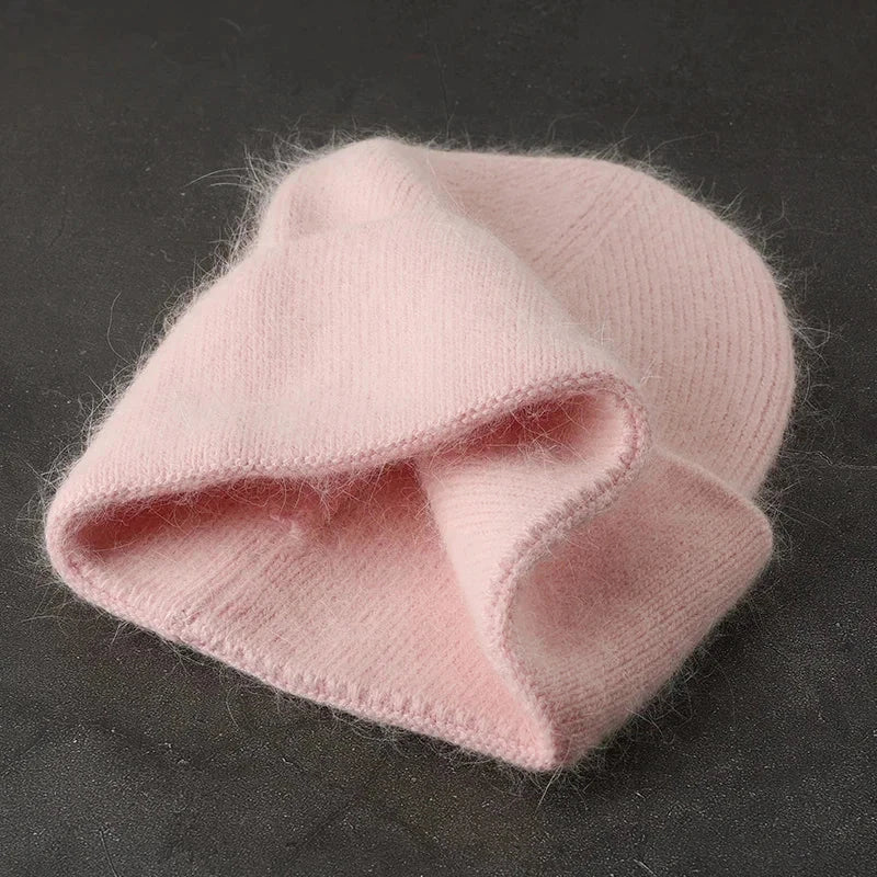 Women solid color fur knitted bonnet beanie in soft pink, perfect for warmth and style.