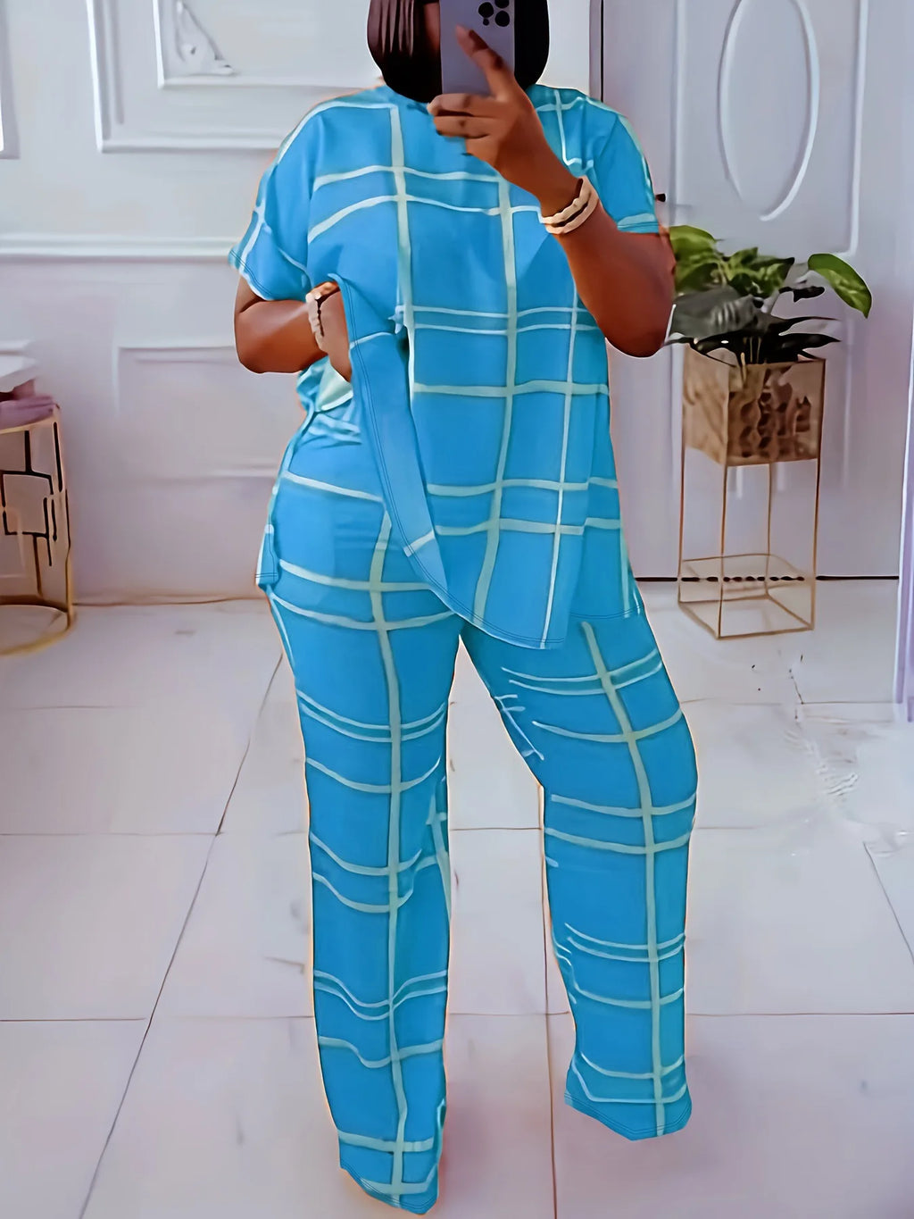 Women’s plus size two-piece set by Plush Fashion Hub featuring a striped grid printed casual round neck top and matching pants.