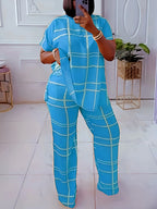 Women’s plus size two-piece set by Plush Fashion Hub featuring a striped grid printed casual round neck top and matching pants.