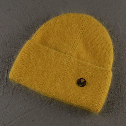 Women solid color fur knitted bonnet, warm ski beanie in soft yellow fabric.