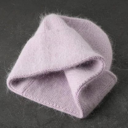 Women solid color fur knitted bonnet, warm ski beanie in soft pink.