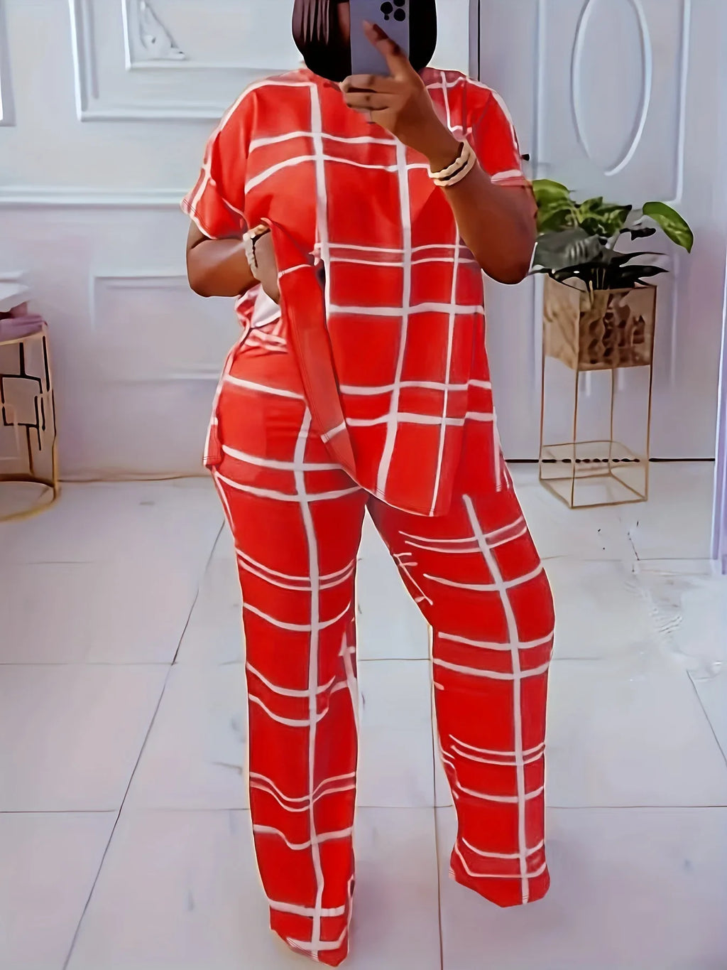 Plus size women’s two-piece casual outfit by Plush Fashion Hub featuring a striped grid printed round neck top and matching pants.