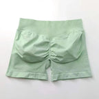 Women's seamless scrunch butt gym shorts in black, designed for high-performance fitness and yoga, from NCLAGEN Gym Wear.