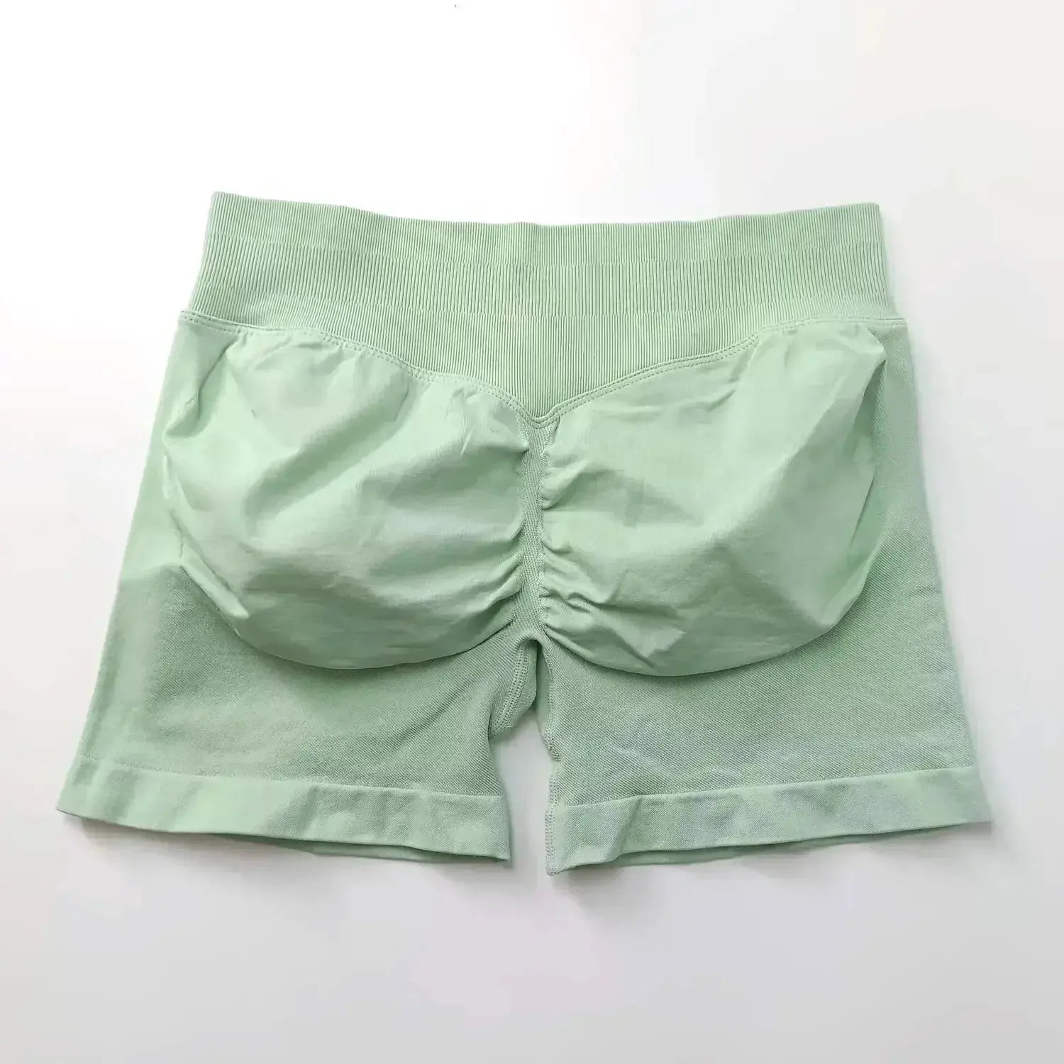 Women's seamless scrunch butt gym shorts in black, designed for high-performance fitness and yoga, from NCLAGEN Gym Wear.