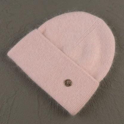 Women solid color fur knitted bonnet beanie in soft pink.