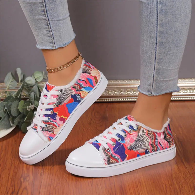 Low top floral canvas shoes for women with breathable design, featuring colorful flower patterns and casual style.