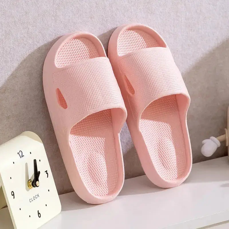 Unisex plush pink EVA bathroom slippers with thick soles and non-slip bottom for indoor use.