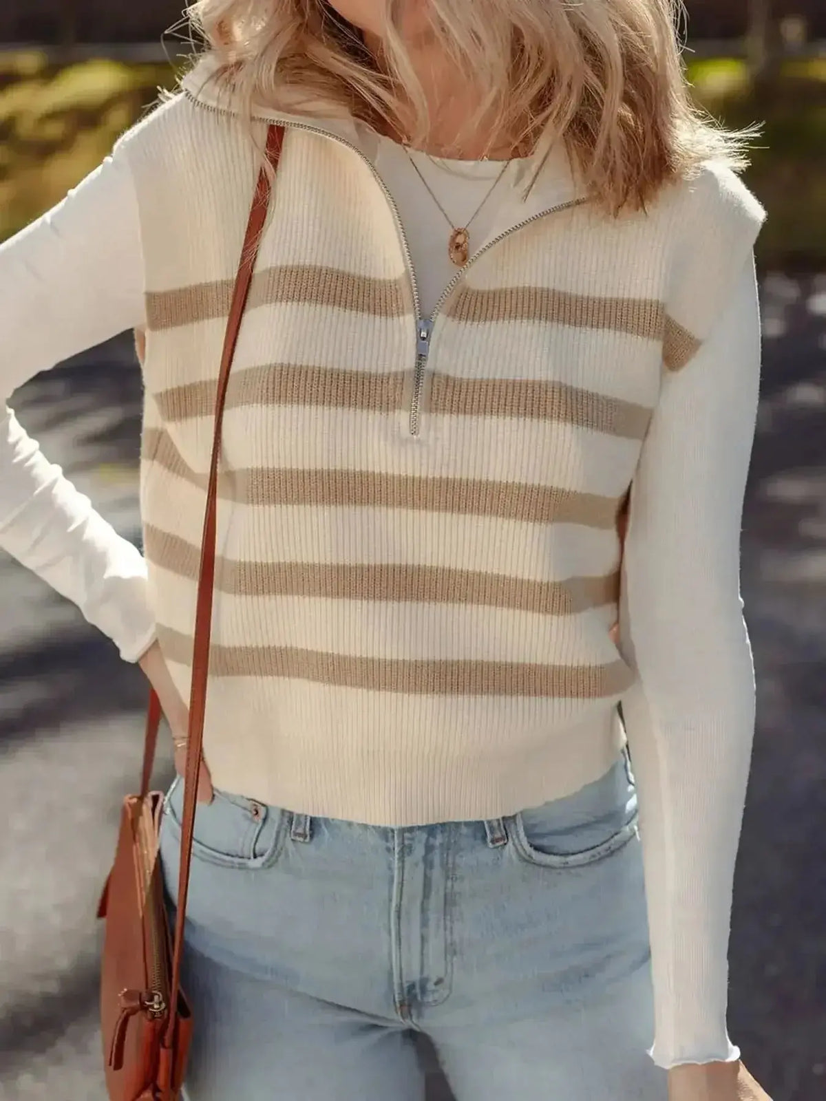 Striped sleeveless ribbed knit sweater vest with half-zip and mock neck from Plush Fashion Hub, showcasing stylish design.