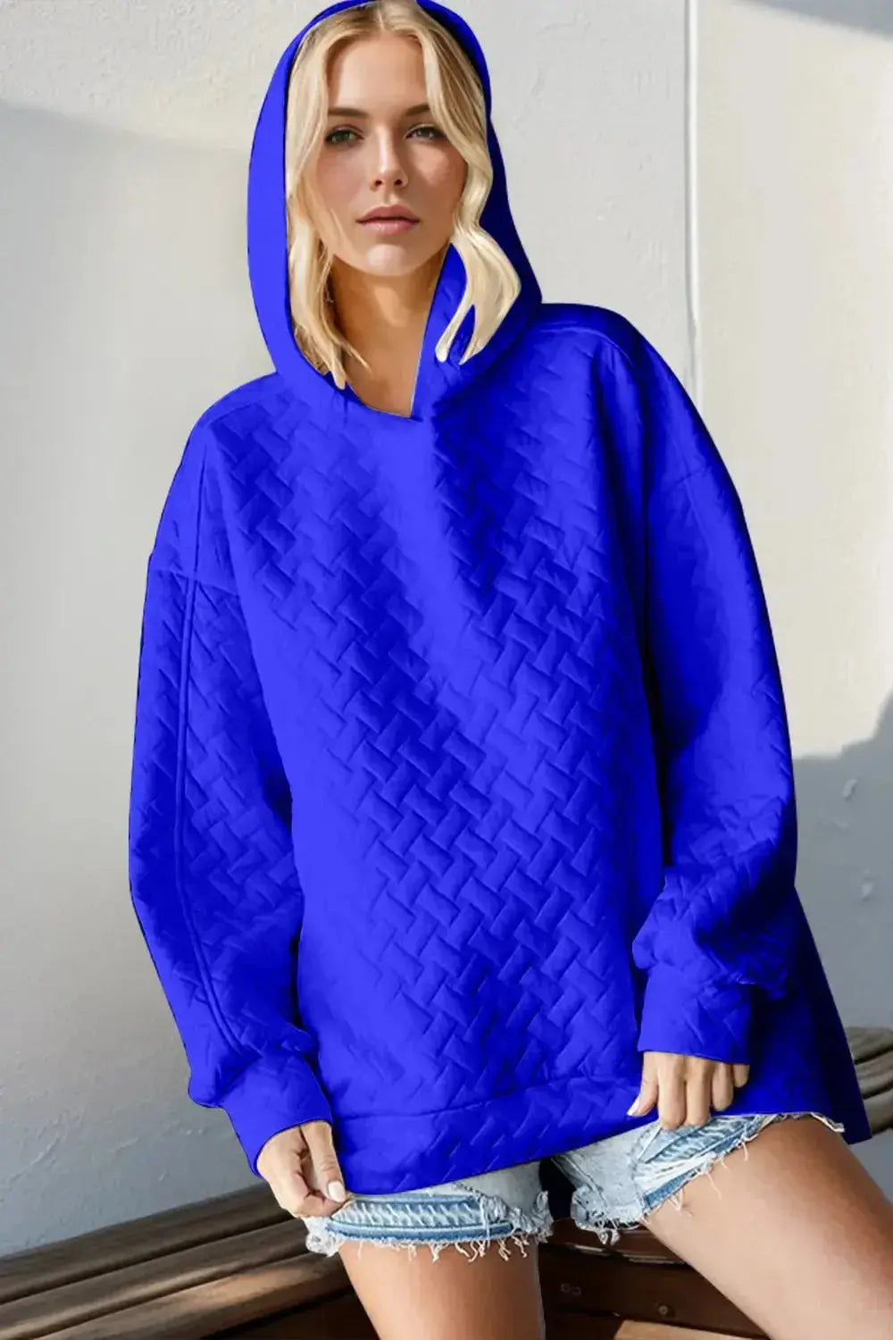 Textured drop shoulder long sleeve hoodie sweater by Plush Fashion Hub, featuring a relaxed fit and cozy design.