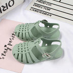 Girls hollow casual flat sandals in pink with open toe design, lightweight and comfortable for everyday wear by Trendy Attic Store01.