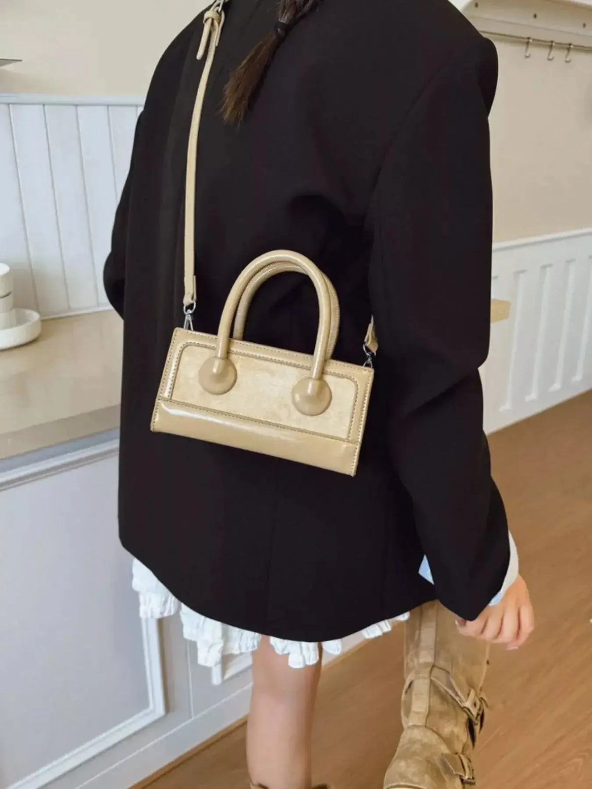 Structured leather crossbody bag with top handle in a sleek design by Plush Fashion Hub, showcasing elegant craftsmanship.