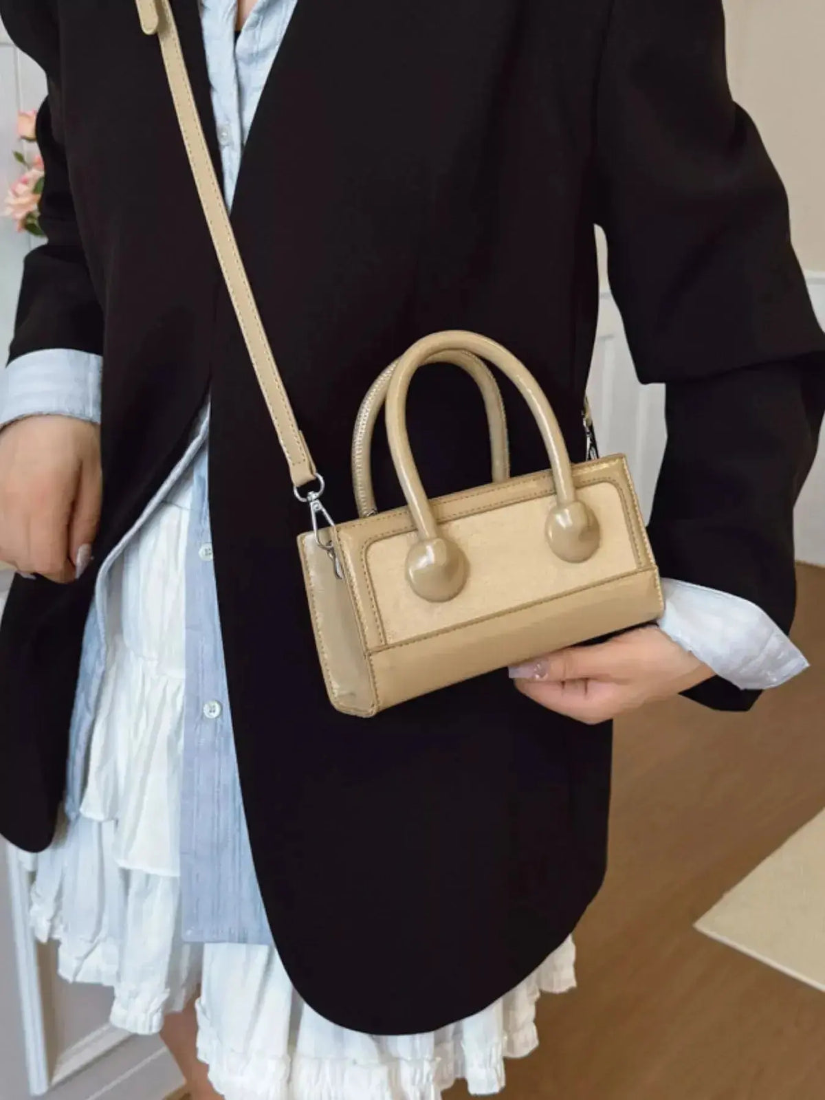 Structured leather top handle crossbody bag with a sleek design by Plush Fashion Hub.
