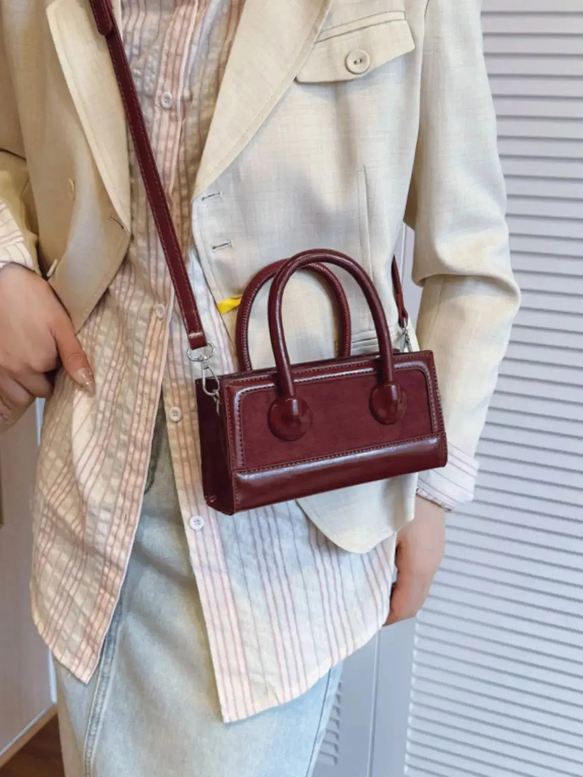 Structured leather crossbody bag with top handle from Plush Fashion Hub, featuring a polished and stylish design.