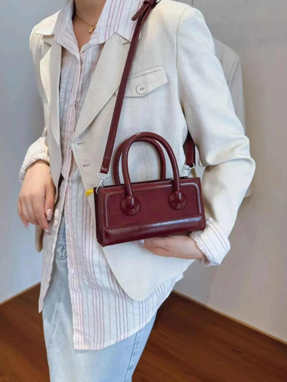 Plush Fashion Hub premium leather top handle crossbody bag with structured design and versatile hand strap.