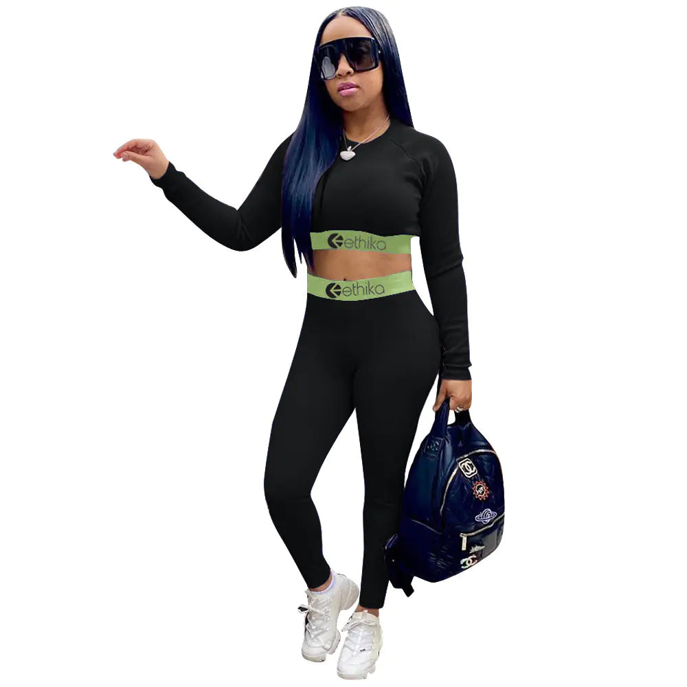 Women's two-piece sports set with letter print, featuring a stylish top and matching leggings for activewear by Trendy Attic Store01.
