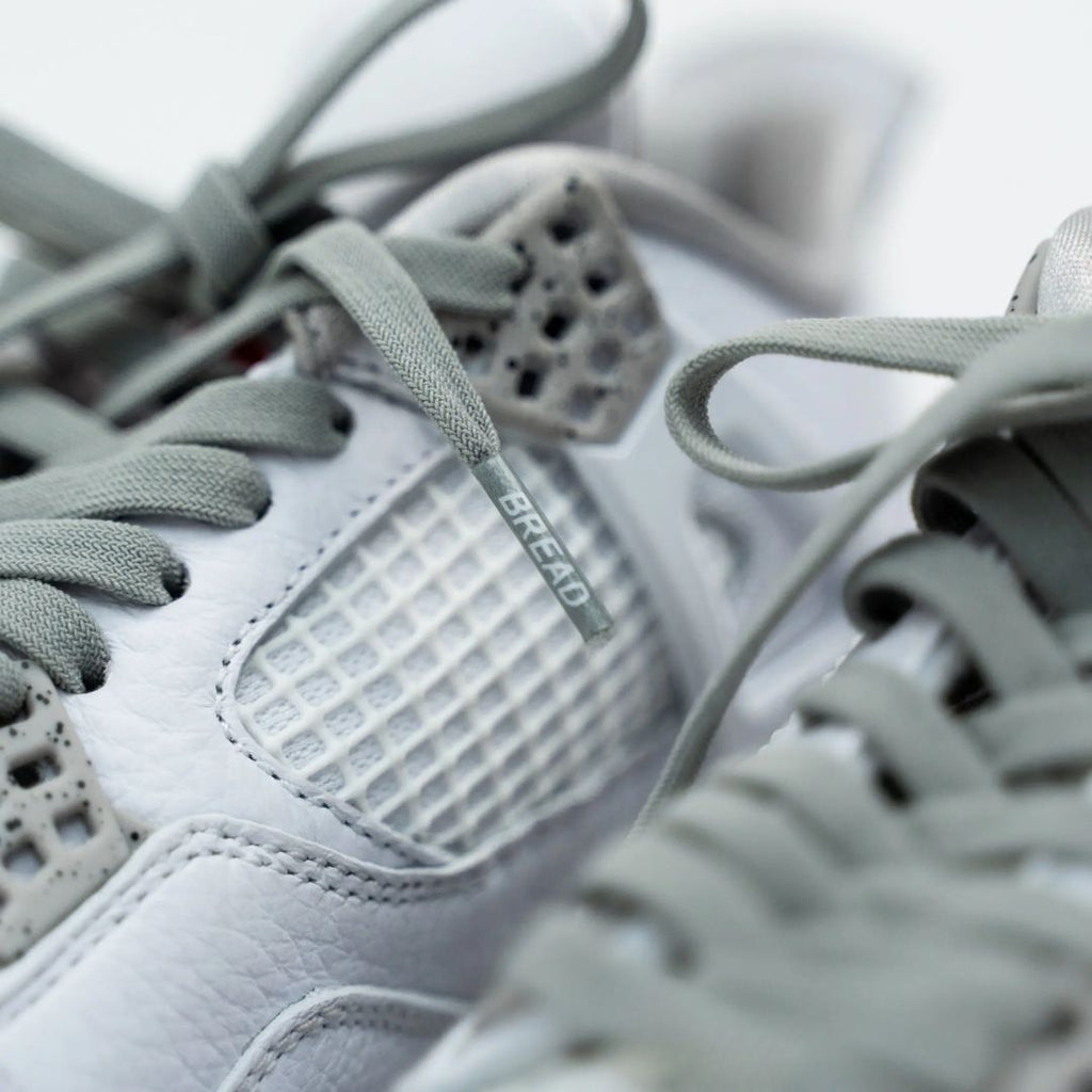 Gray elastic shoelaces by Bread in Vulture Gray color, shown laced through sneaker eyelets for a snug fit.