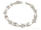 Vintage cubic zirconia sandals and flowers sterling silver bracelet from Plush Fashion Hub, featuring intricate jewelry designs.
