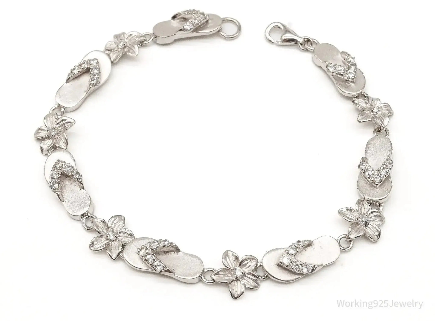 Sterling silver vintage bracelet with cubic zirconia sandals and flower charms, crafted by Plush Fashion Hub.