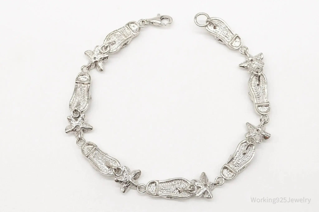 Vintage sterling silver bracelet with floral design and cubic zirconia sandals charm, crafted by Plush Fashion Hub.
