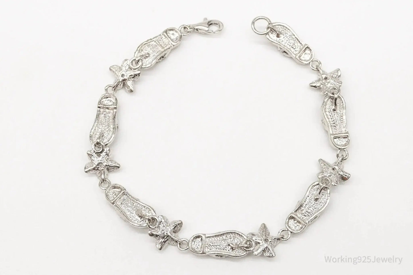 Sterling silver vintage bracelet with cubic zirconia sandals and flower designs, crafted by Plush Fashion Hub.