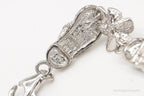 Vintage cubic zirconia sandals and flower sterling silver bracelet, elegant jewelry set showcasing intricate design details.