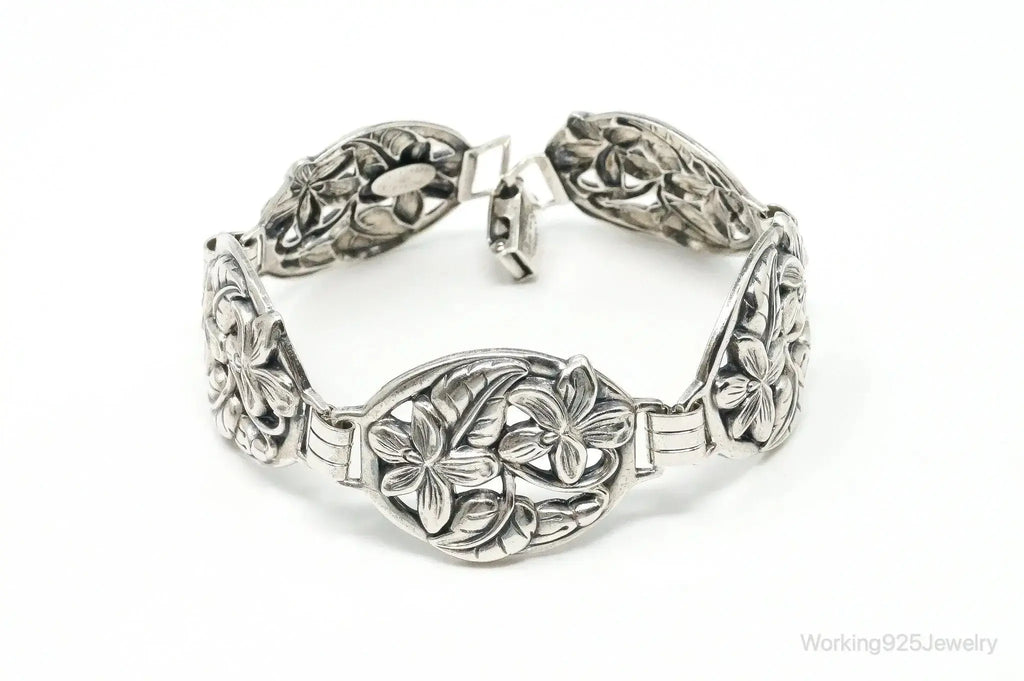 Vintage Danecraft sterling silver bracelet with floral panel design, featuring intricate craftsmanship and classic jewelry style.