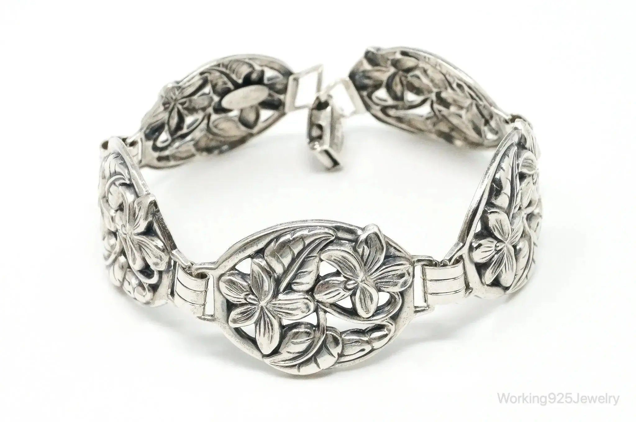 Vintage Danecraft sterling silver bracelet with floral panel design, featuring intricate craftsmanship and elegant jewelry styling.