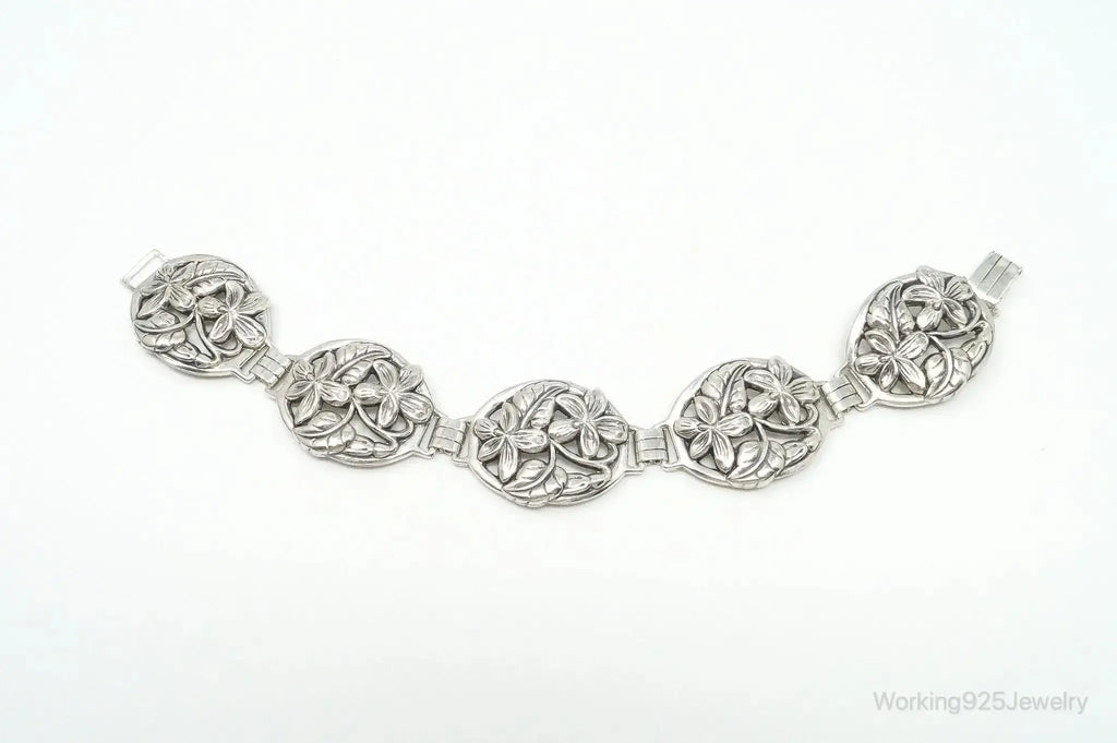 Vintage Danecraft sterling silver bracelet with floral panel design, featuring intricate craftsmanship and elegant jewelry style.
