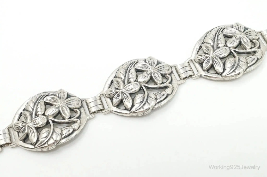 Vintage Danecraft sterling silver bracelet with floral panel design, featuring intricate craftsmanship and elegant jewelry style.