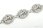Vintage Danecraft sterling silver bracelet with floral panel design, featuring intricate craftsmanship and elegant jewelry style.