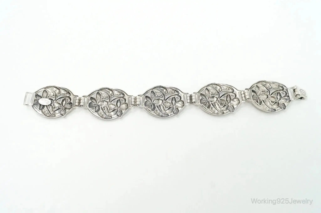 Vintage Danecraft sterling silver bracelet with floral panel design, featuring intricate craftsmanship and elegant jewelry style.