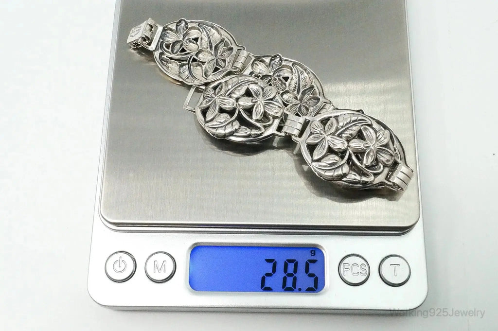 Vintage Danecraft sterling silver bracelet with floral panel design, showcasing intricate jewelry craftsmanship and elegant style.