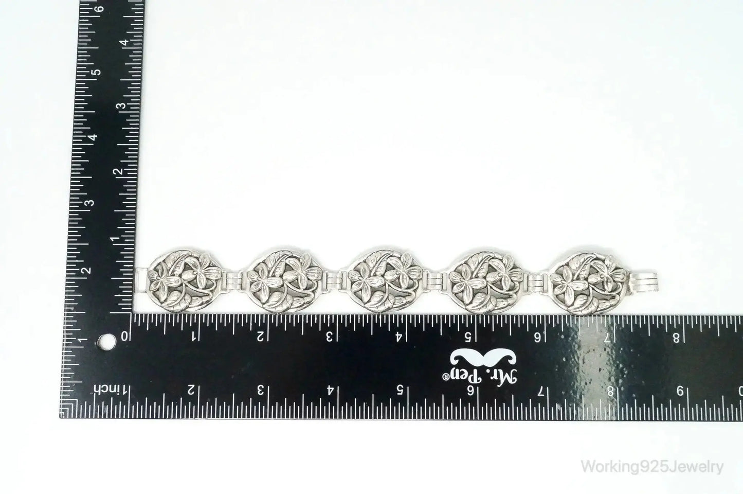 Vintage Danecraft sterling silver floral panels bracelet with intricate floral designs, crafted by Plush Fashion Hub.