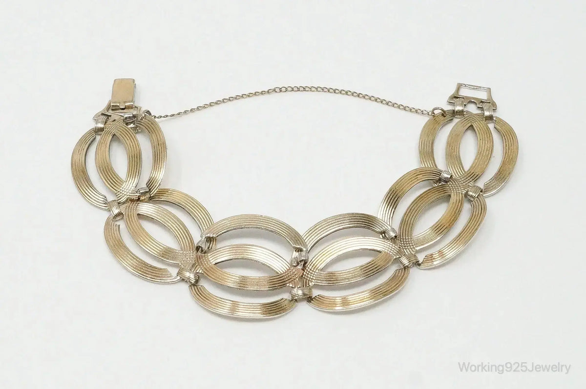 Vintage designer silver bracelet with 14K gold accents featuring Art Deco style, crafted by Plush Fashion Hub.