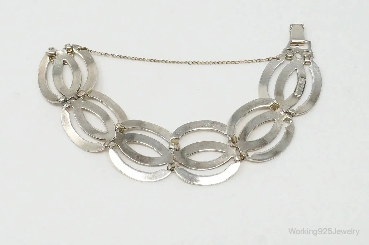 Vintage designer sterling silver bracelet with 14K gold accents, featuring art deco symmetalic design, by Plush Fashion Hub.