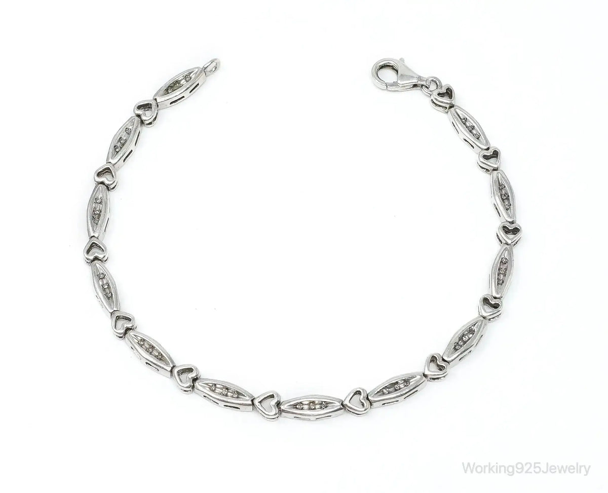 Vintage diamond-linked hearts sterling silver bracelet from Plush Fashion Hub, showcasing intricate heart-shaped charms and shiny silver links.
