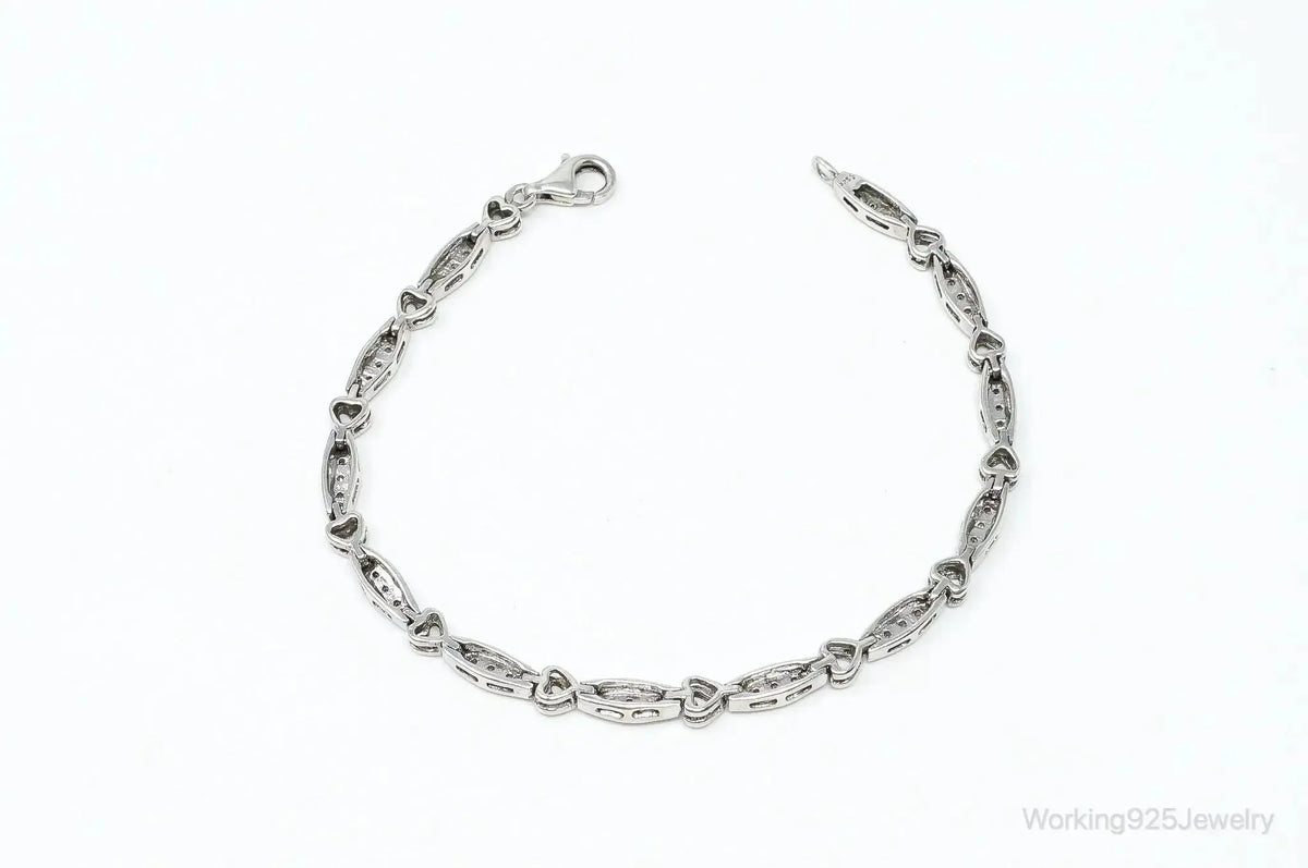 Sterling silver bracelet with vintage diamond-linked heart charms, crafted by Plush Fashion Hub.