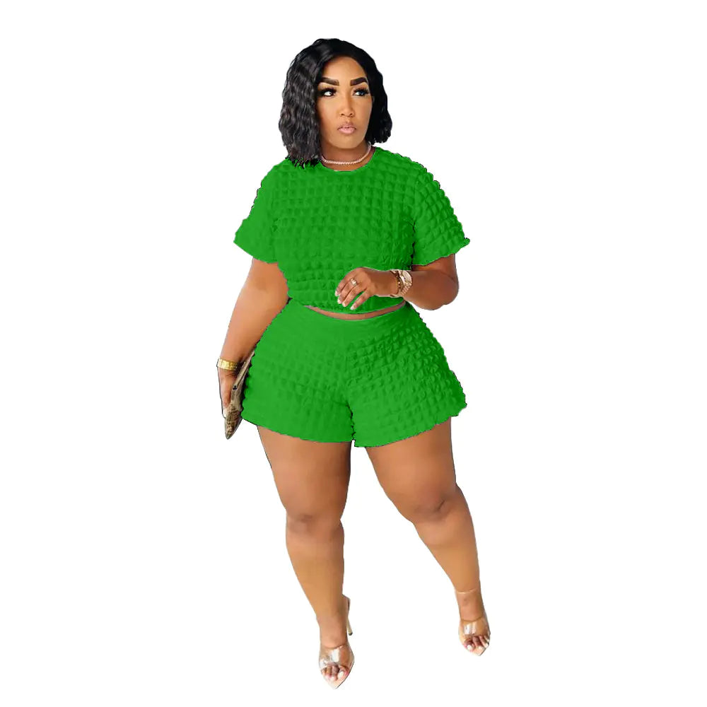 Plus size women's summer casual two-piece set featuring trendy shorts and top, styled for a comfortable, fashionable look.