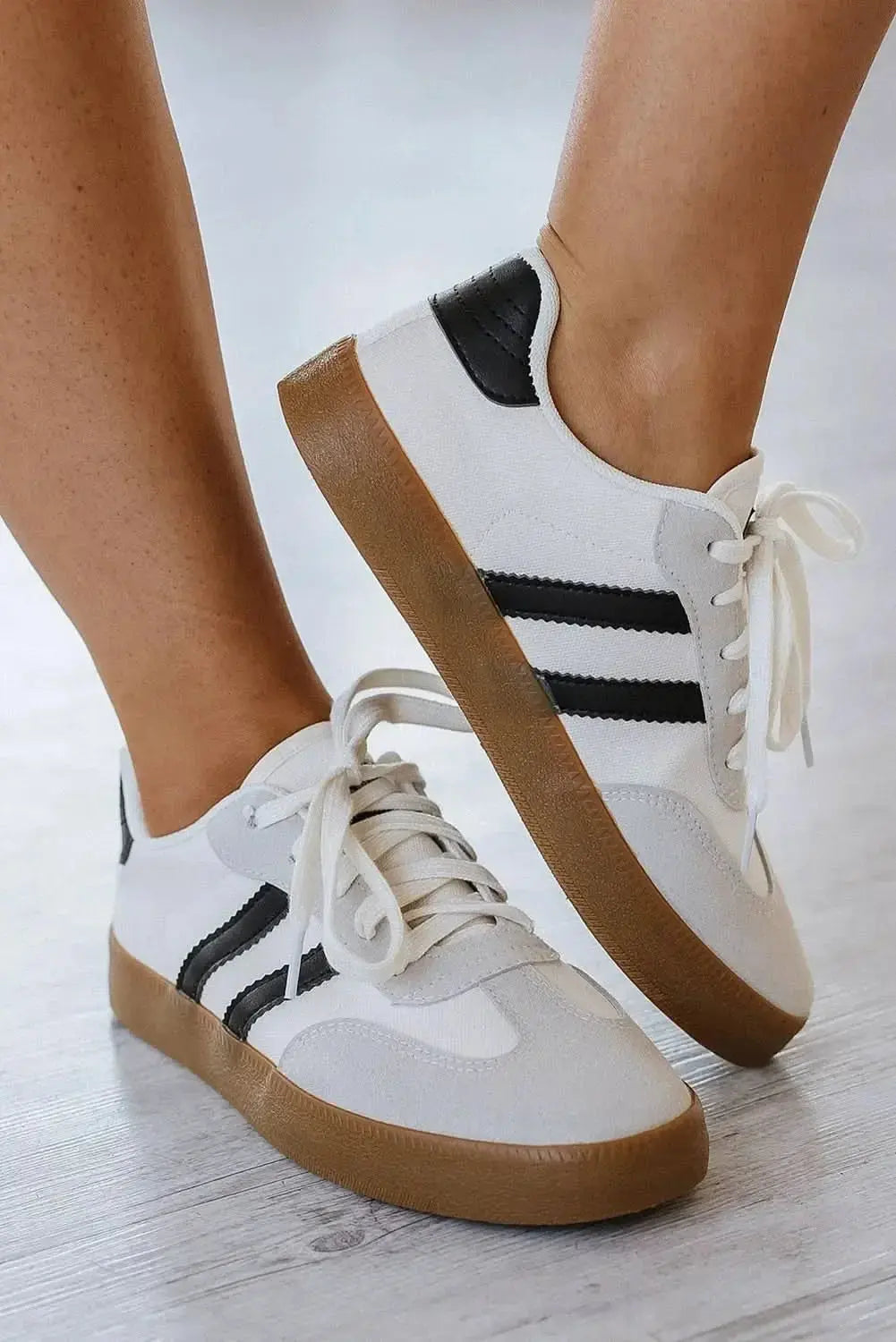 Women's white striped lace-up sneakers by Plush Fashion Hub, featuring a casual flat design for everyday comfort and style.