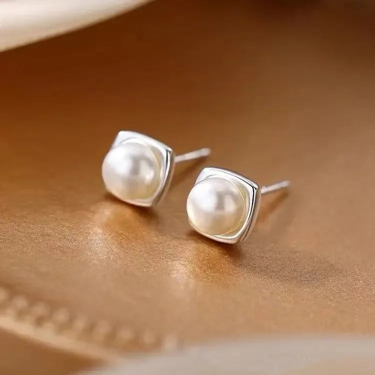 Sterling silver pearl stud earrings with minimalist geometric design, elegant jewelry for women from Plush Fashion Hub