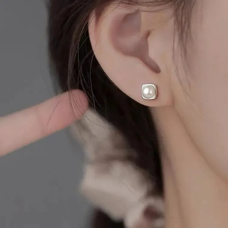 Sterling silver pearl stud earrings featuring minimalist geometric design, elegant jewelry for women by Plush Fashion Hub.