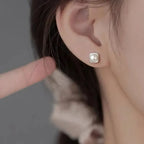 Sterling silver pearl stud earrings featuring minimalist geometric design, elegant jewelry for women by Plush Fashion Hub.