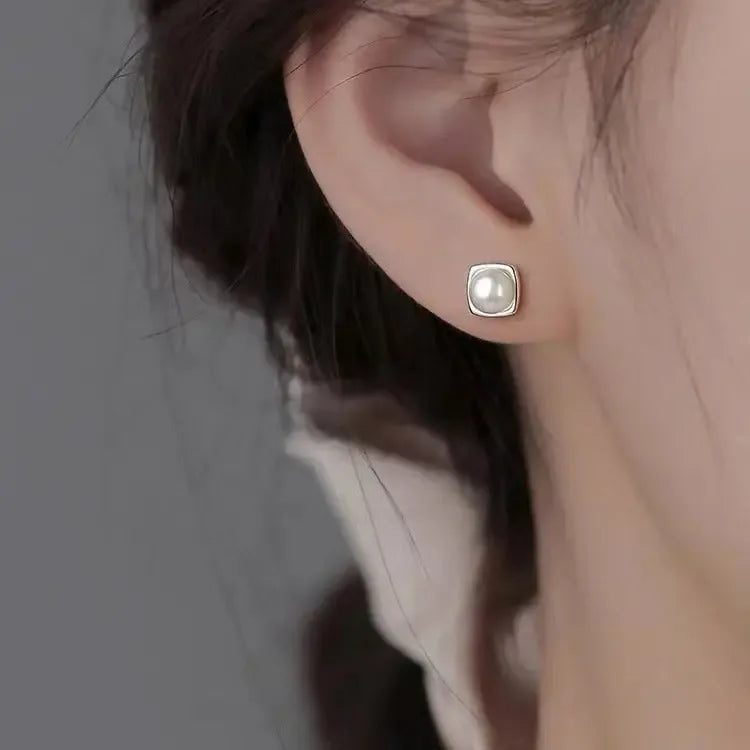 Sterling silver pearl stud earrings featuring minimalist geometric design, elegant jewelry for women from Plush Fashion Hub.