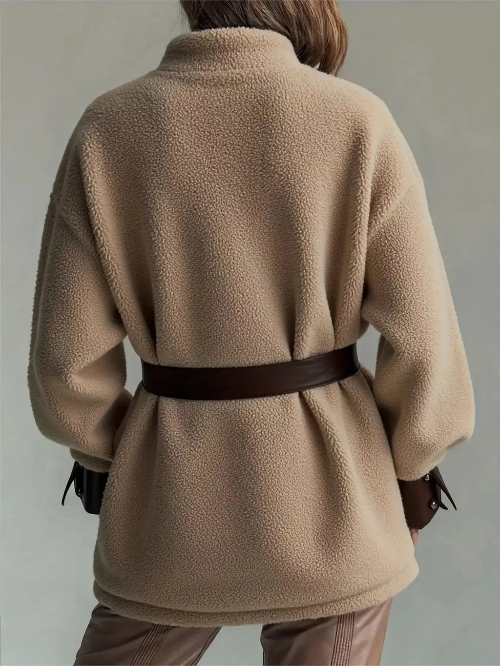 Women’s belted sherpa jacket with leather trim, featuring plush material and stylish design, by Trendsi.