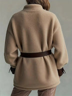 Women’s belted sherpa jacket with leather trim, featuring plush material and stylish design, by Trendsi.