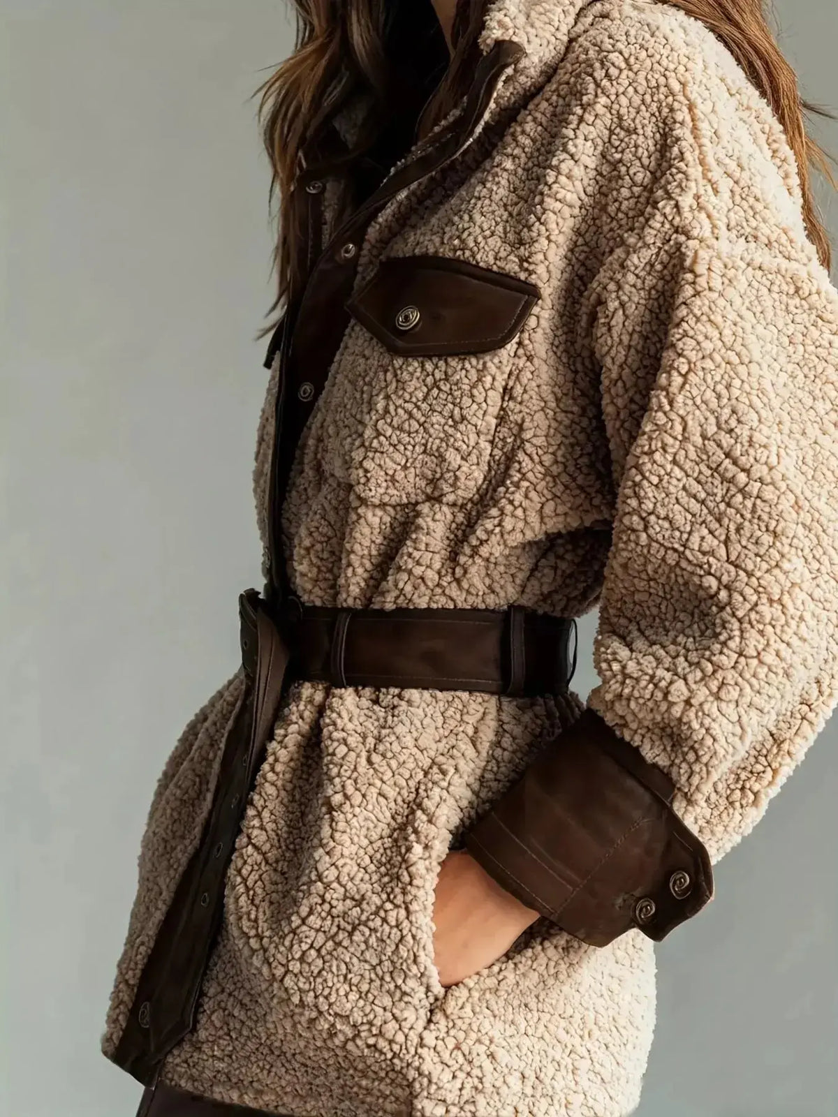 Women's belted Sherpa jacket with leather trim, stylish and cozy, from Plush Fashion Hub featuring a classic collar and waist belt.