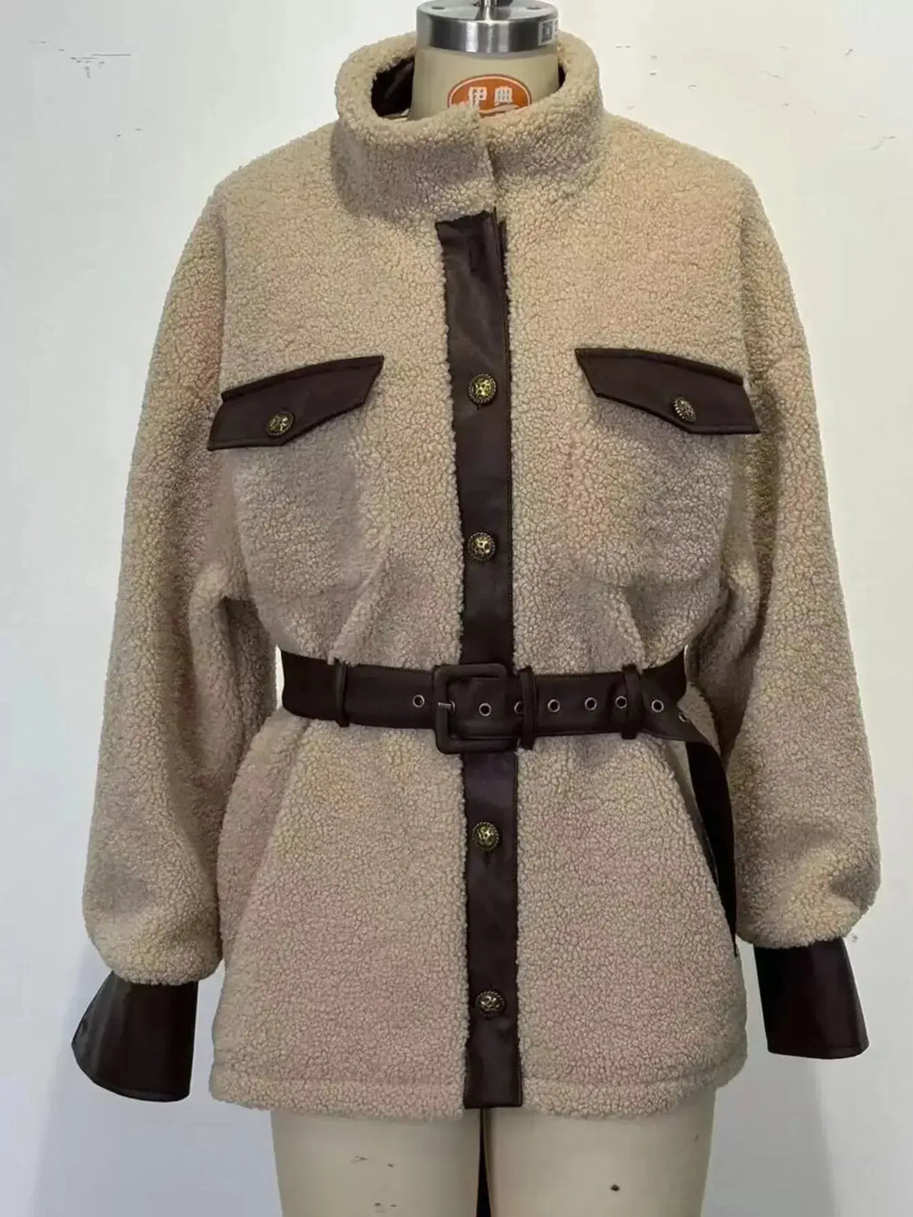 Women’s belted sherpa jacket with leather trim, featuring plush fabric and stylish design from Trendsi.