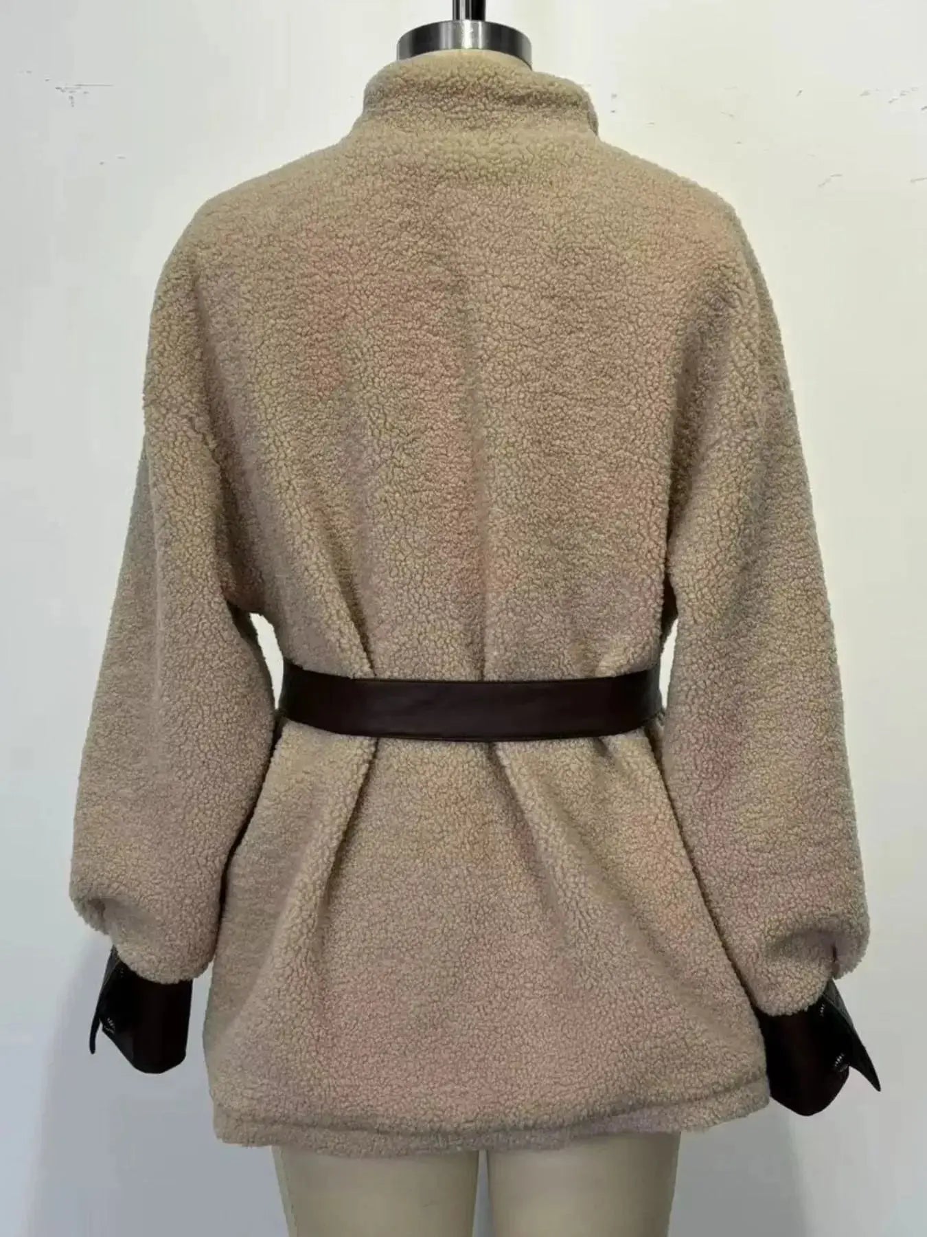 Women’s belted Sherpa jacket with leather trim, stylish and cozy, featuring a plush fabric and fashionable design by Trendsi.