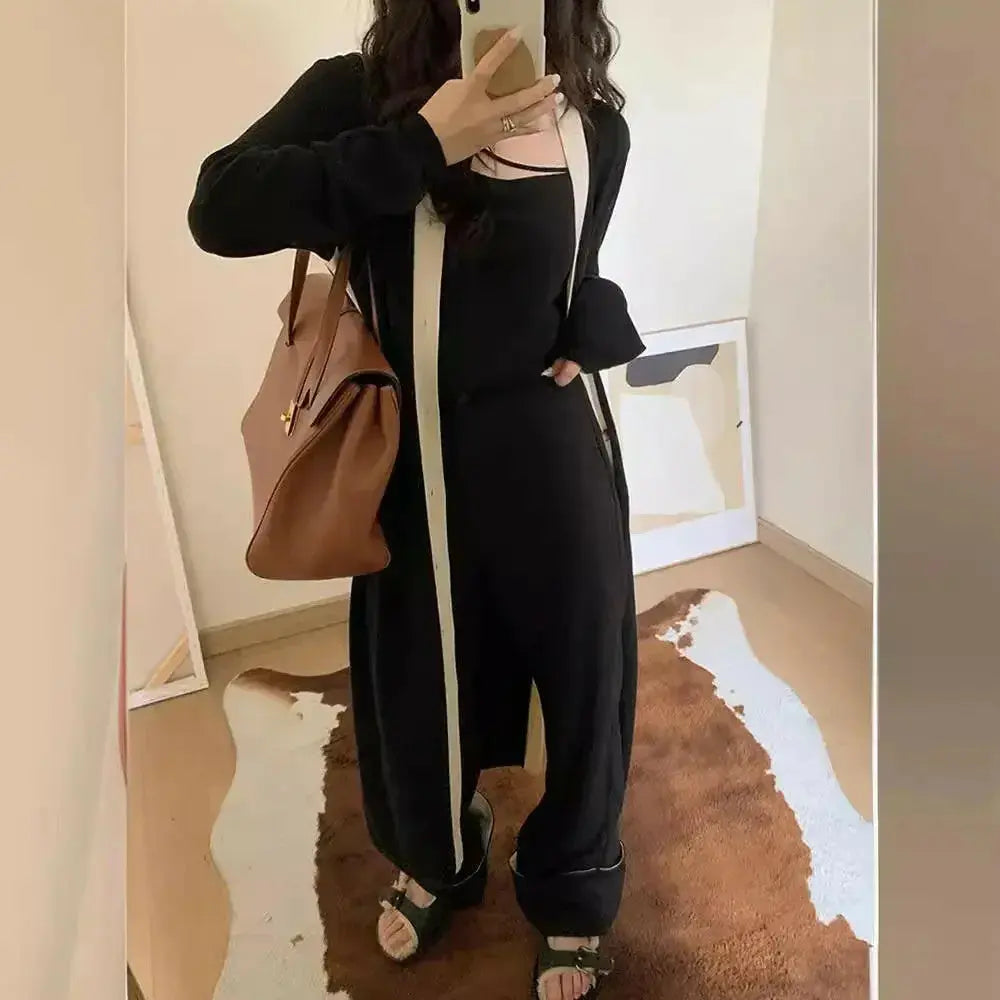 Black long sleeve knitted A-line midi dress for women by Plush Fashion Hub, showcased on a model.